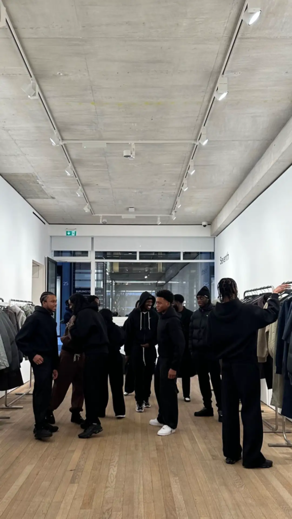 Group of people browsing clothes in a modern minimalist store.