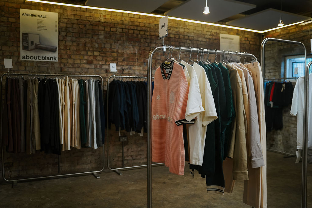 Modern retail shelving unit displaying clothing in a holiday pop-up store