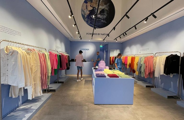 Colorful clothing display in modern retail store with event hire furniture