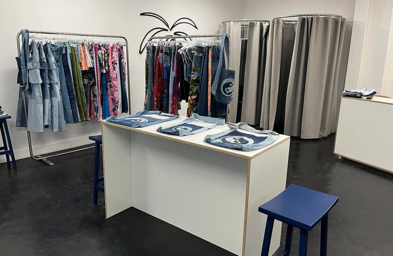Modern boutique with jeans and changing rooms.